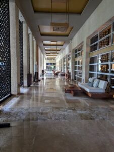 Elegant restaurant entrances on resort grounds, featuring lush landscaping, inviting guests to dine in style.