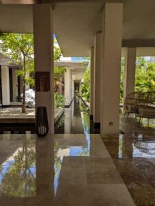 Resort grounds featuring elegant water pillars surrounded by lush greenery and ambient lighting, creating a tranquil and luxurious atmosphere.