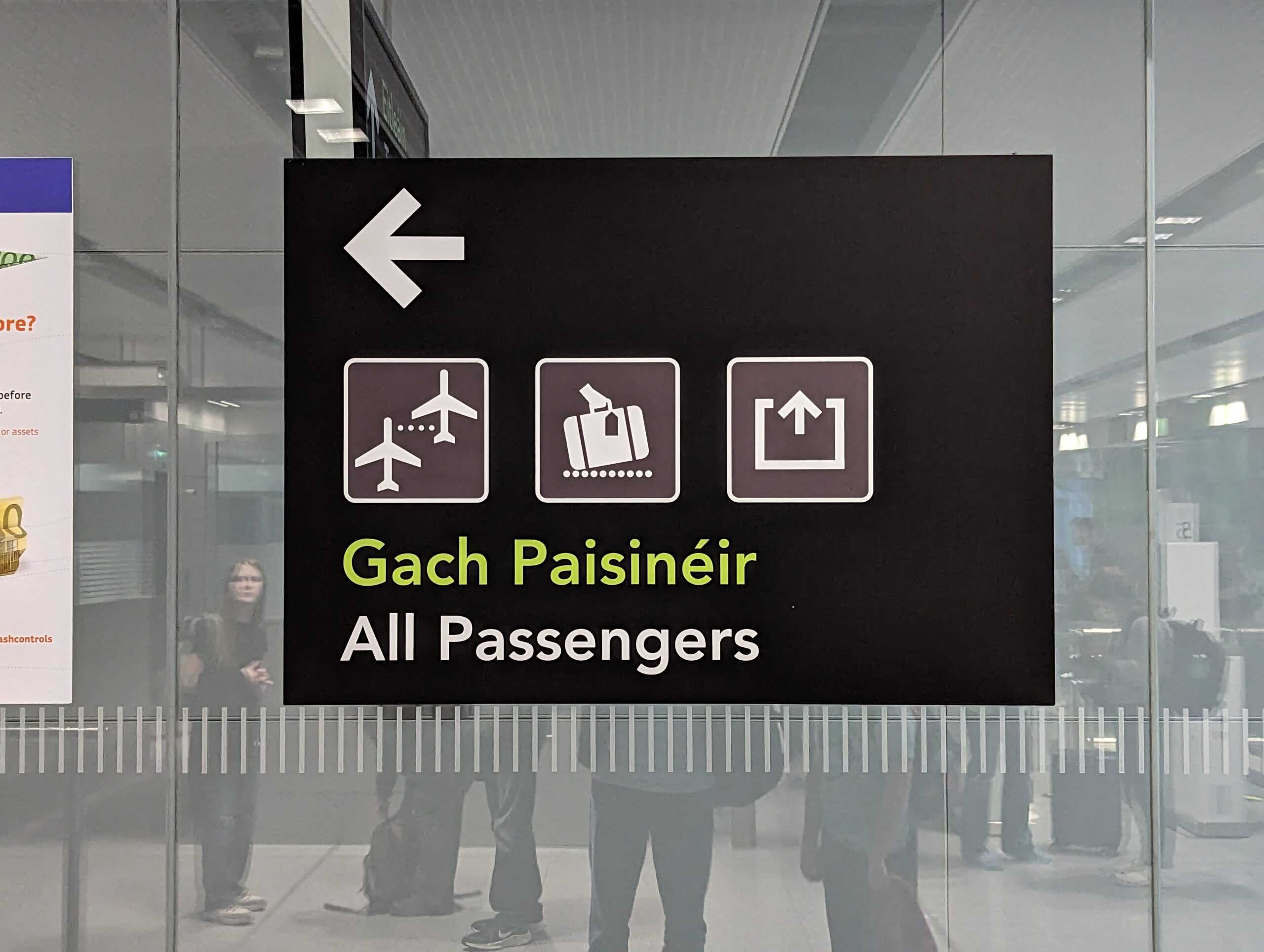 Sign directing all passengers, written in English and Gaelic